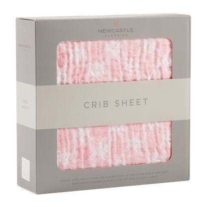 Primrose pink plaid cotton muslin baby crib sheet with soft, breathable fabric and pink checkered design for cozy nursery bedding.