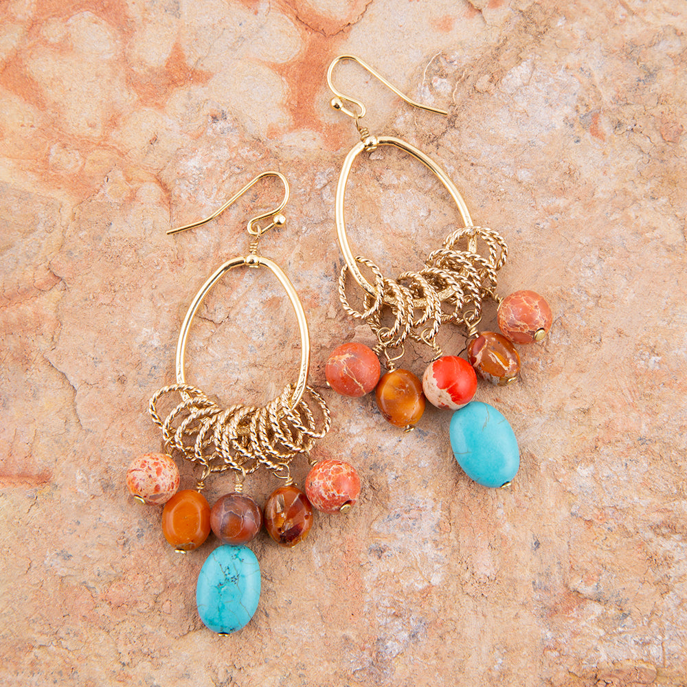 Start2Finish Canyon Blue Magnesite and Orange Jasper chandelier earrings with gold accents, featuring vibrant blue and orange gemstone beads.