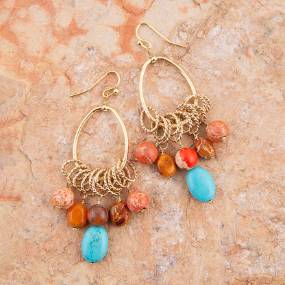 Start2Finish Canyon Blue Magnesite and Orange Jasper chandelier earrings with gold accents, featuring vibrant blue and orange gemstone beads.