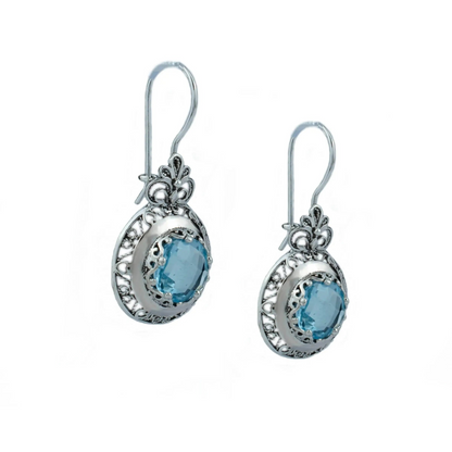 Silver drop earrings with blue topaz gemstones and intricate filigree floral design for women.