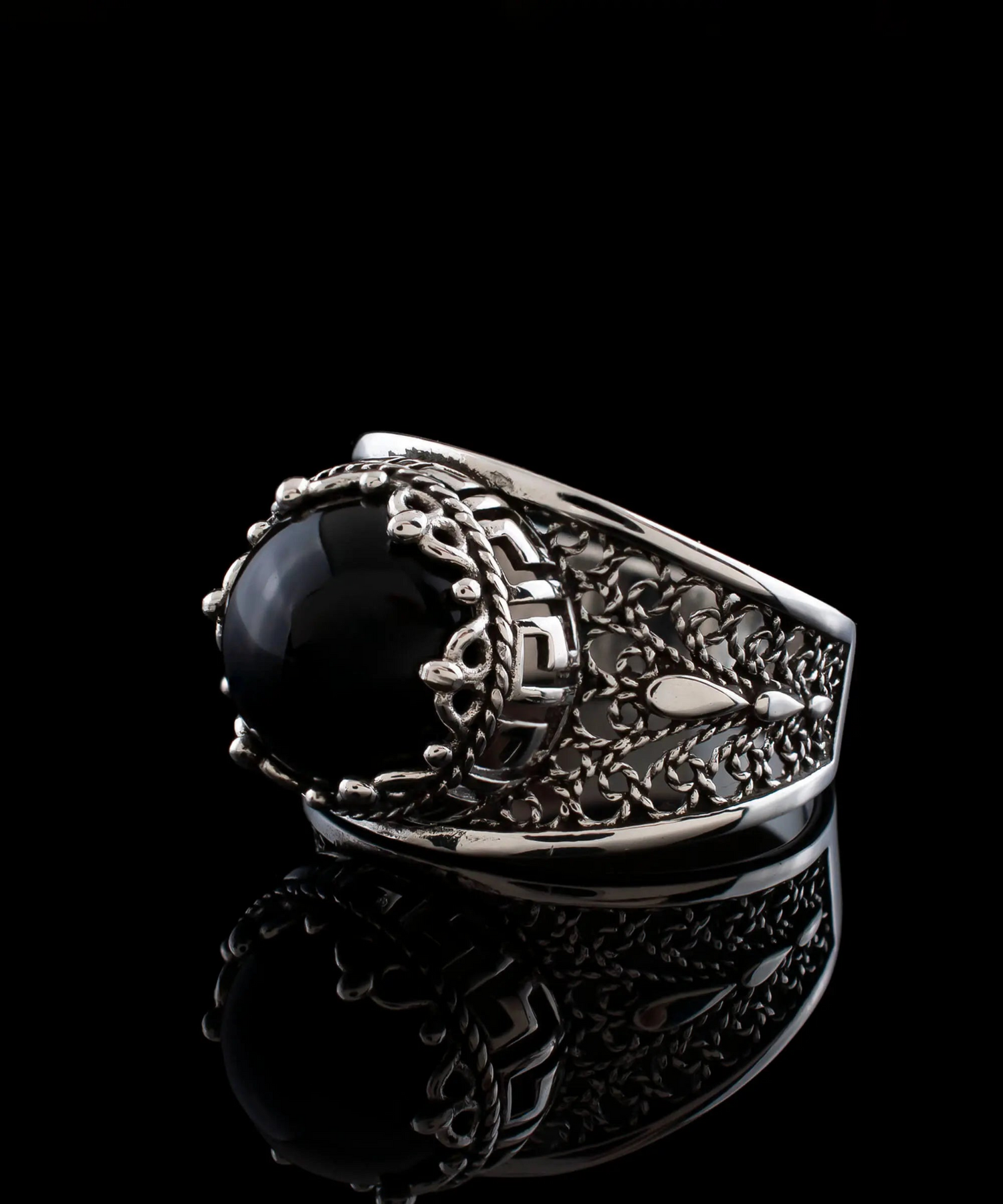 Silver cocktail ring with black onyx gemstone featuring a meander pattern filigree design for women.