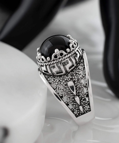 Silver cocktail ring with black onyx gemstone featuring meander pattern filigree art design for women.