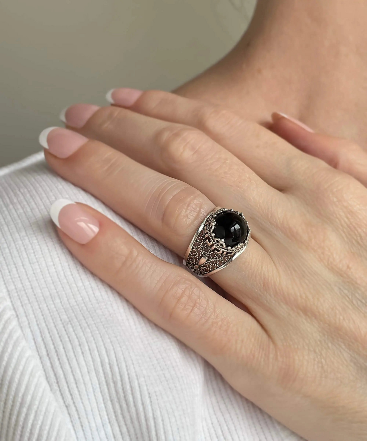Silver cocktail ring with black onyx gemstone featuring a meander pattern filigree design, designed for women.