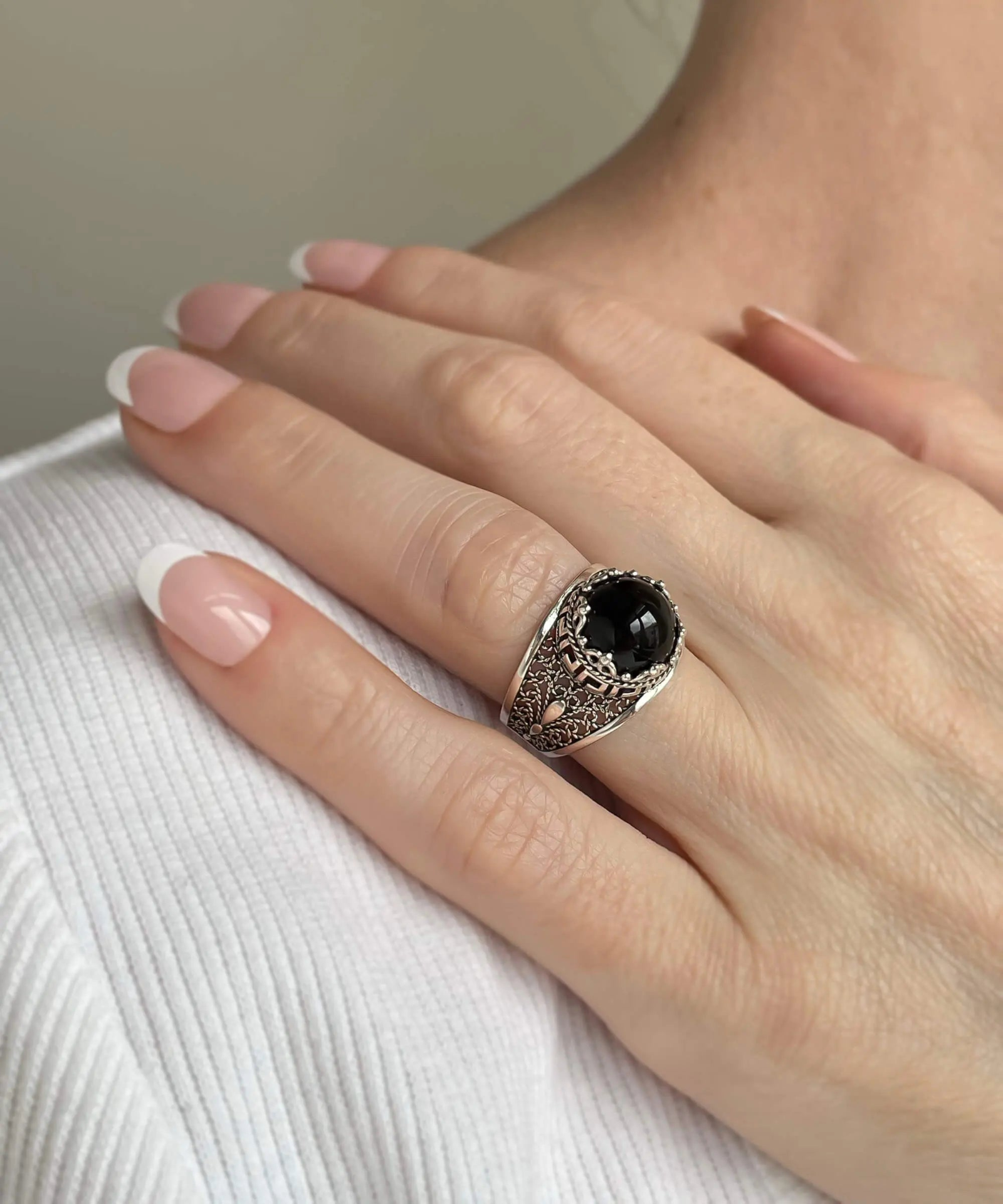Silver cocktail ring with black onyx gemstone featuring a meander pattern filigree design, designed for women.