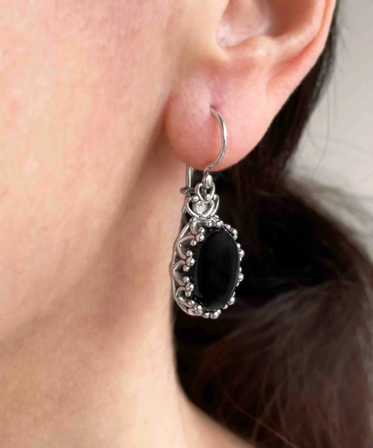 Filigree art black onyx gemstone crown silver drop earrings for women, featuring oval design and intricate jewelry craftsmanship.