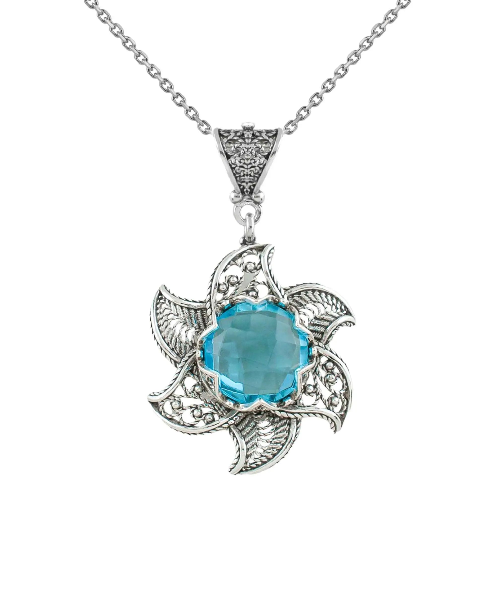 Sterling silver filigree lotus flower pendant necklace with blue topaz gemstone, intricate jewelry design, elegant and detailed craftsmanship.