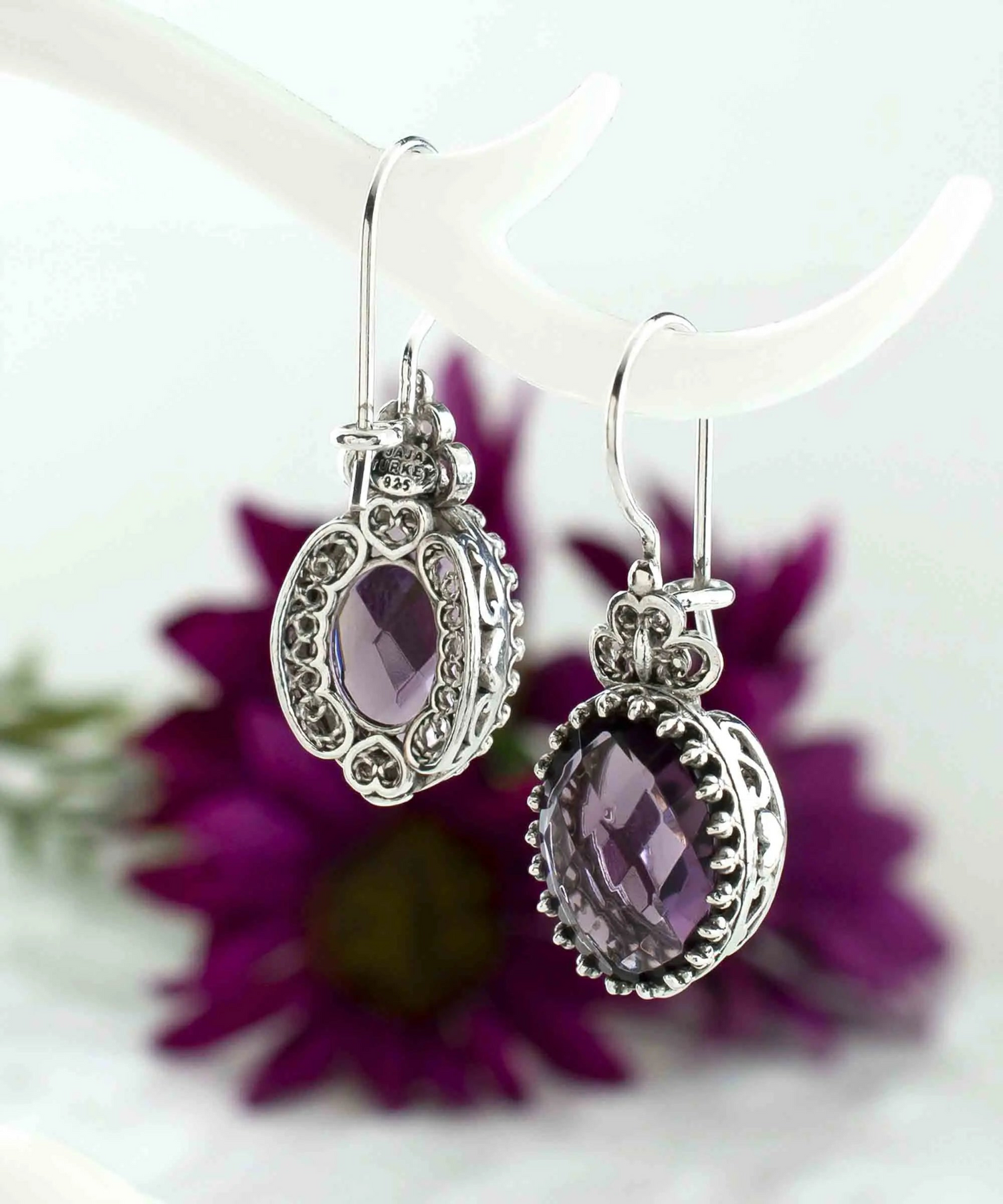 Silver oval drop earrings with filigree design, amethyst gemstone hearts, detailed jewelry for women.