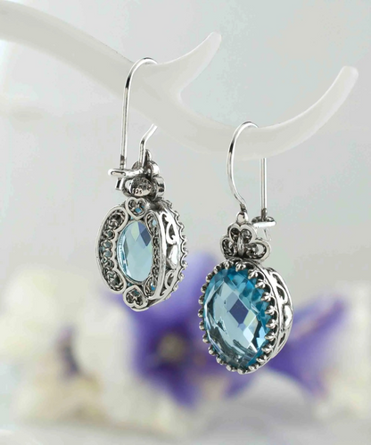 Silver oval drop earrings with filigree design and blue topaz gemstone heart for women, detailed jewelry from Start2Finish.