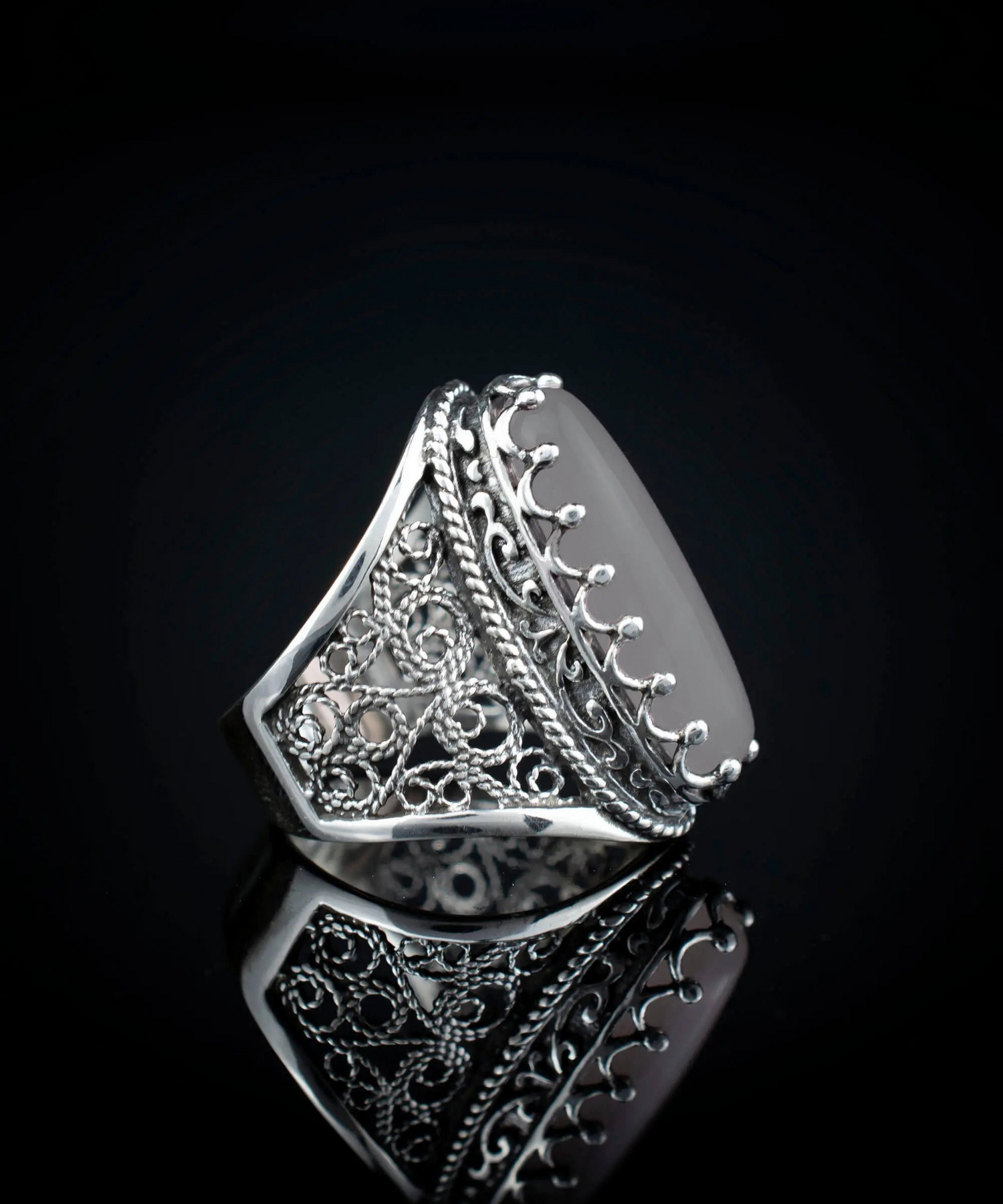 Silver long statement ring featuring gray moonstone gemstone with intricate filigree art design for women.