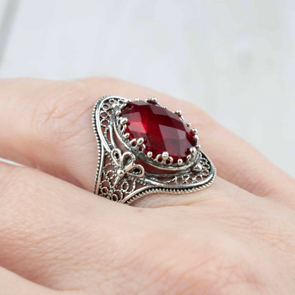 Silver woman’s statement ring featuring ruby quartz gemstone with intricate filigree design, crafted by Start2Finish jewelry brand.
