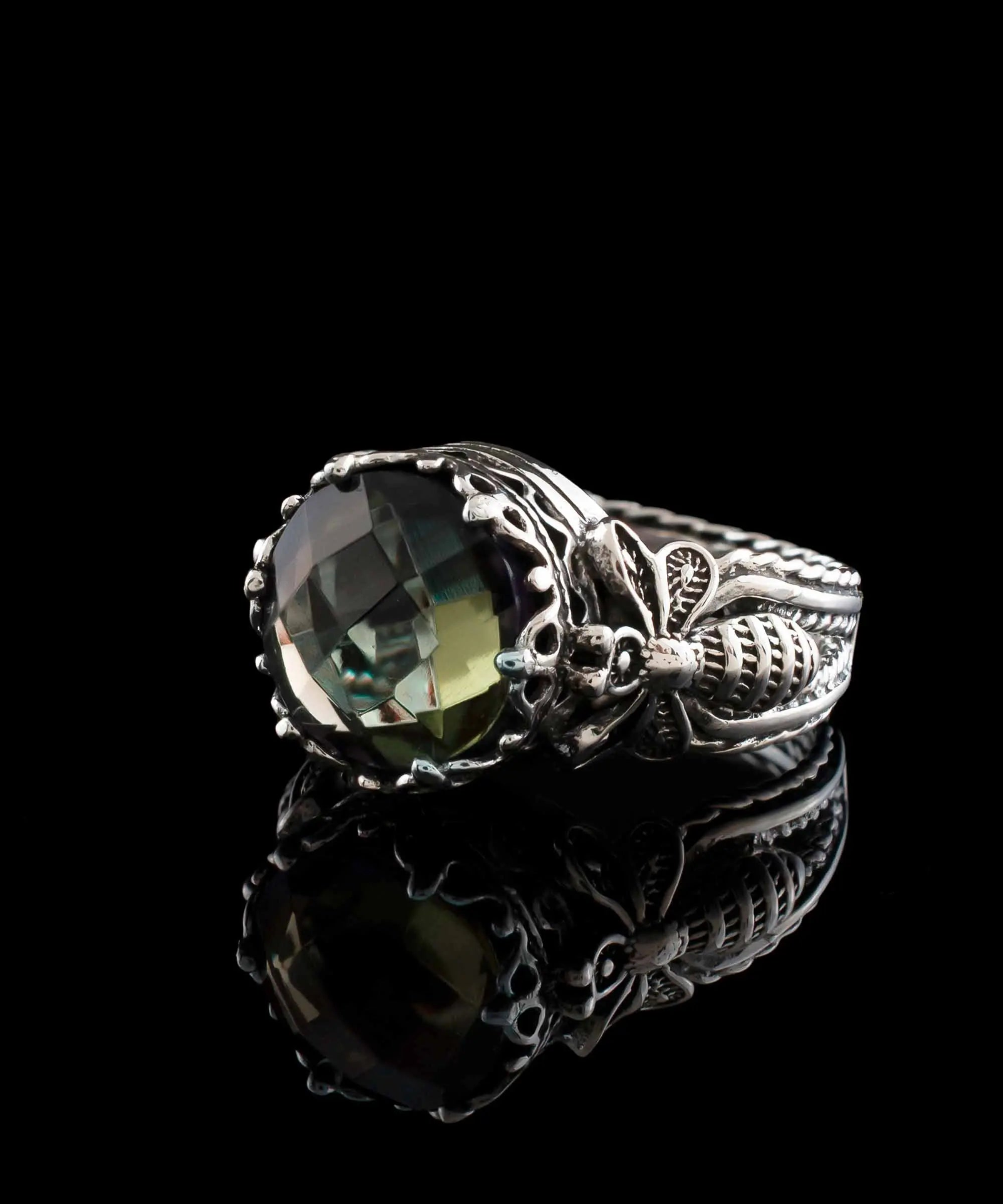 Silver cocktail ring featuring detailed alexandrite gemstone and filigree art design for women.