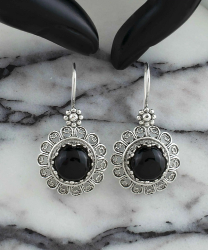 Silver drop earrings with filigree flower design and black onyx gemstones for women, featuring intricate jewelry craftsmanship.