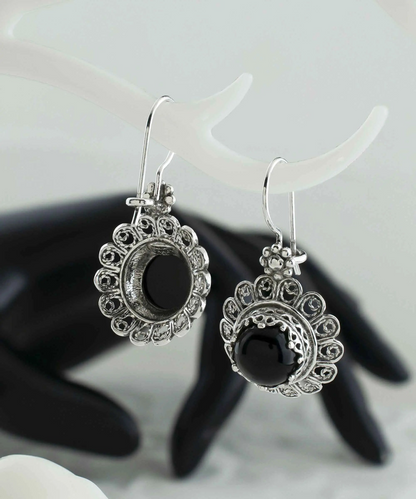 Silver drop earrings featuring black onyx gemstones with intricate filigree flower design for women.