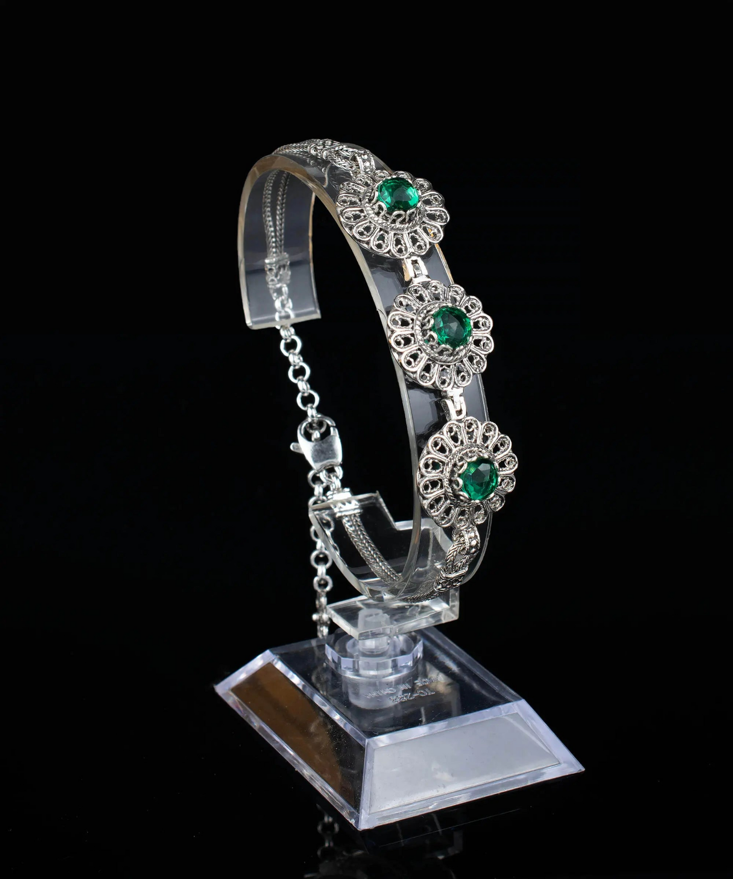 Silver link bracelet with intricate filigree design and emerald gemstone accents, crafted by Start2Finish for women.