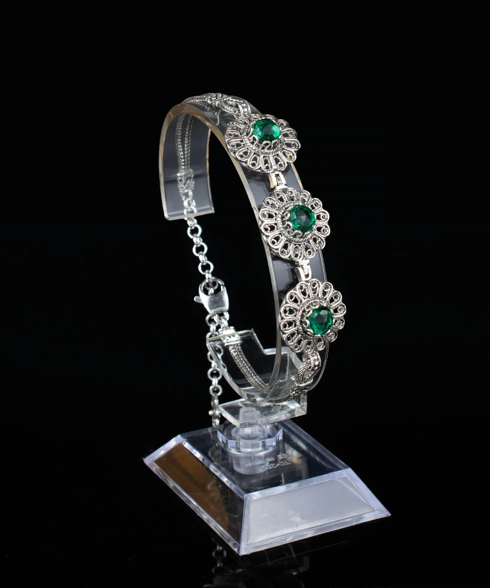 Silver link bracelet with intricate filigree design and emerald gemstone accents, crafted by Start2Finish for women.
