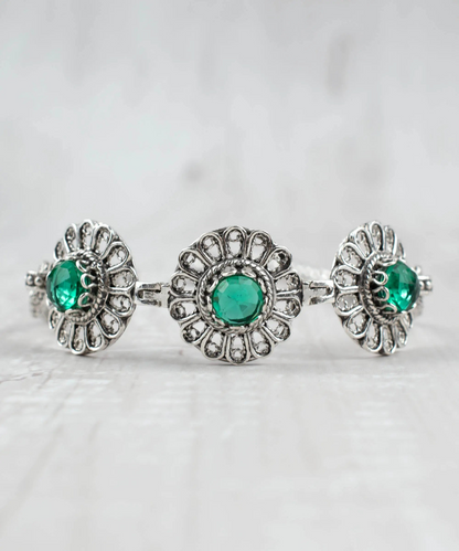 Filigree art emerald gemstone silver link bracelet for women, featuring intricate silver jewelry design and vibrant green emeralds.