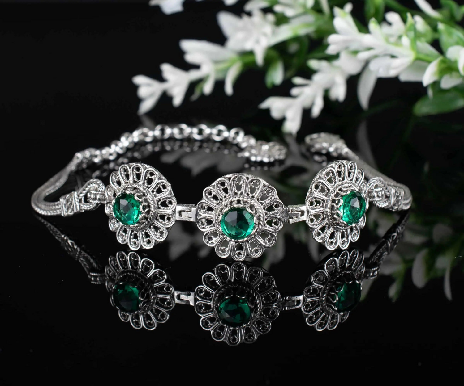 Silver link bracelet featuring filigree art and emerald gemstones for women, crafted by Start2Finish jewelry brand.