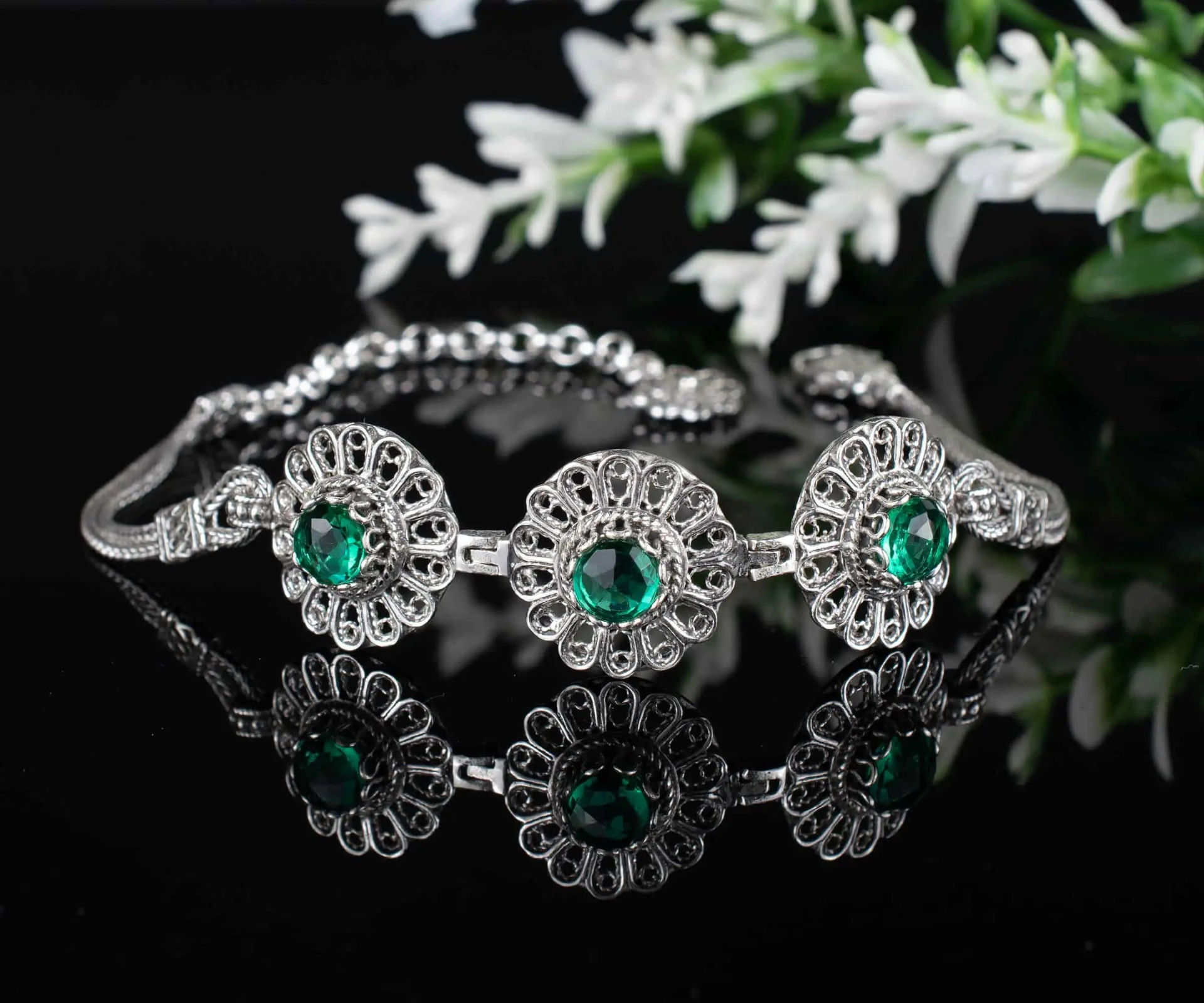 Silver link bracelet featuring filigree art and emerald gemstones for women, crafted by Start2Finish jewelry brand.