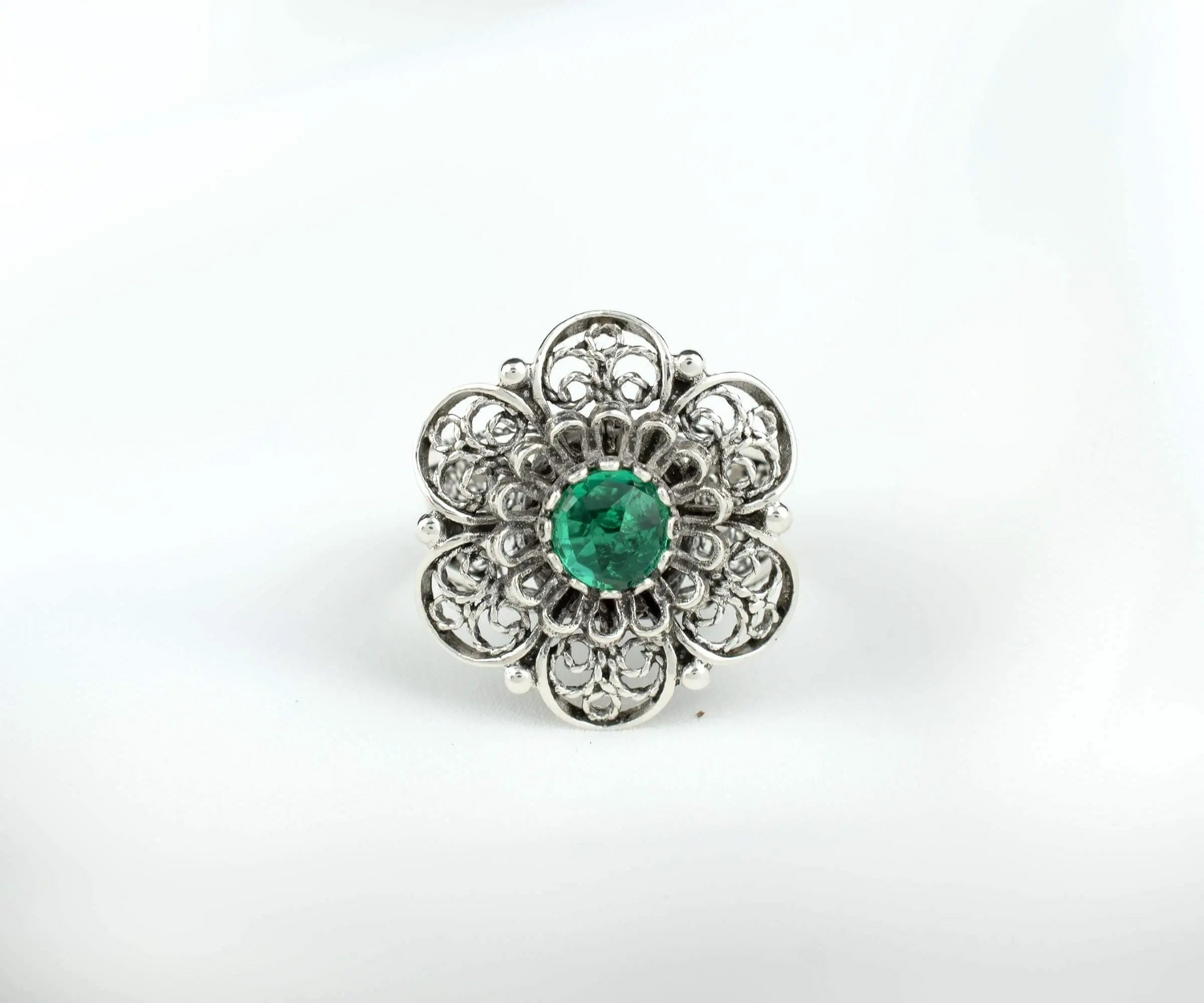 Silver statement ring with intricate filigree design and emerald gemstone for women, crafted by Start2Finish.