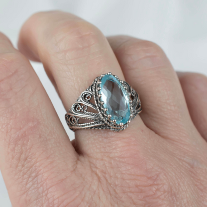 Silver cocktail ring featuring blue topaz gemstone and angel filigree design, crafted by Start2Finish for women.
