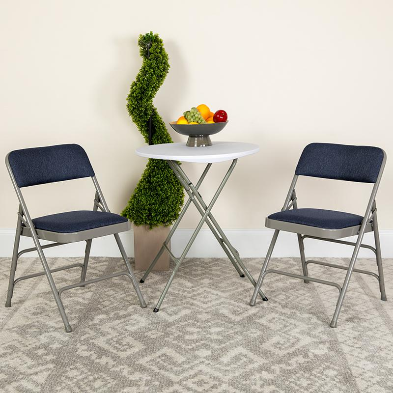 Two navy fabric HERCULES Series curved folding chairs with triple bracing, double hinges, and metal frames, displayed side by side.