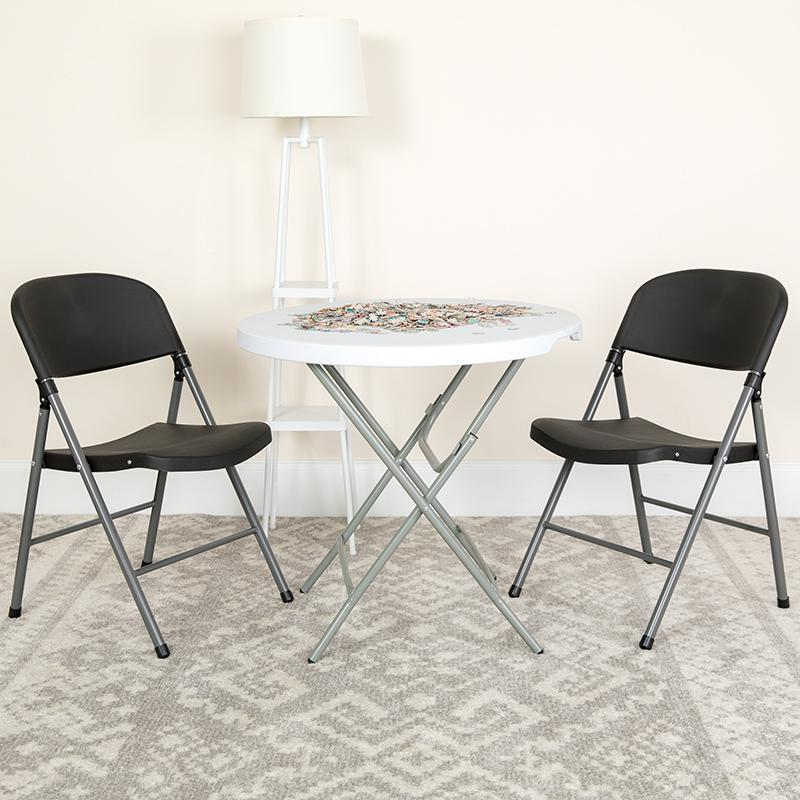 Two black plastic folding chairs with charcoal metal frames, HERCULES Series 330 lb. capacity, shown stacked and ready for use.