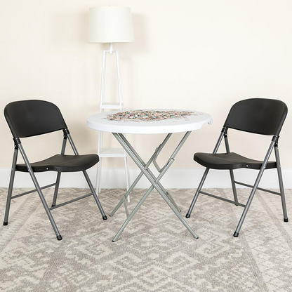 Two black plastic folding chairs with charcoal metal frames, HERCULES Series 330 lb. capacity, shown stacked and ready for use.