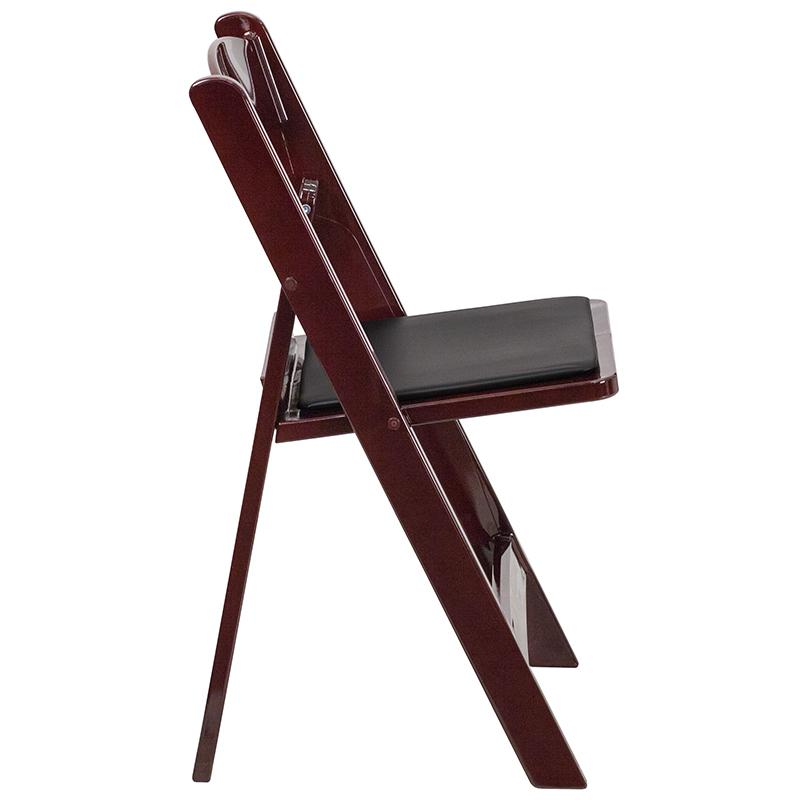 Two red mahogany resin folding chairs with black vinyl padded seats, part of the HERCULES Series, by Start2Finish.
