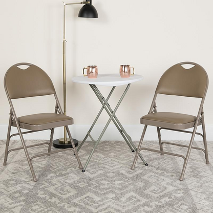 Two beige HERCULES Series triple-braced vinyl metal folding chairs with easy-carry handles from Start2Finish.