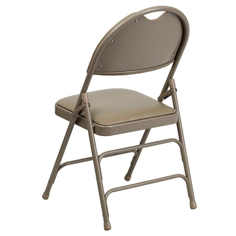 Two beige HERCULES Series vinyl folding chairs with triple-braced metal frames and easy-carry handles, ideal for versatile furniture use.