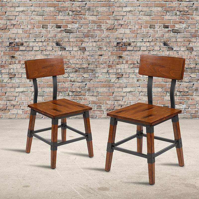 Set of two rustic antique walnut industrial wood dining chairs with sturdy frames and vintage-inspired design.