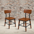 Set of two rustic antique walnut industrial wood dining chairs with sturdy frames and vintage-inspired design.