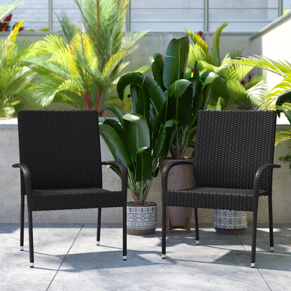 Set of two black stackable wicker dining chairs with armrests, weather-resistant steel frames for indoor or outdoor use.