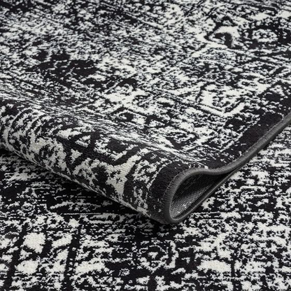 Distressed vintage Persian woven area rug with intricate patterns and warm tones, showcasing rustic, handcrafted craftsmanship.