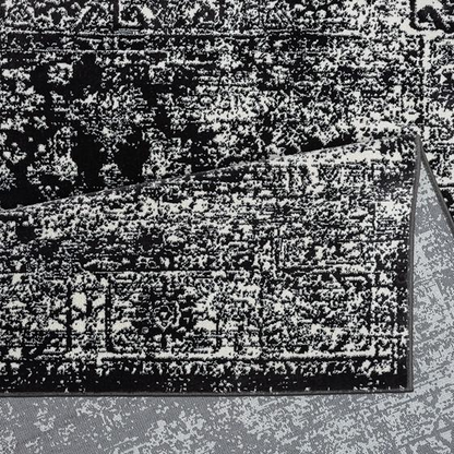 Distressed vintage Persian woven area rug with intricate patterns and faded colors, showcasing handcrafted rug craftsmanship.