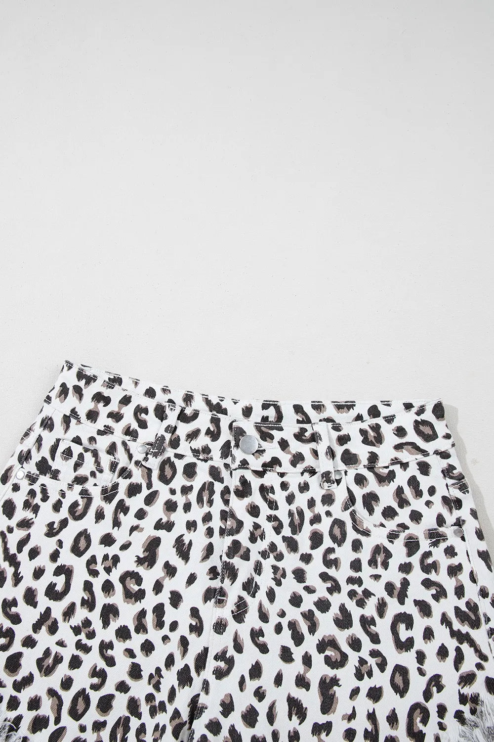 Leopard print frayed hem denim shorts for women by Ruby Styx, showing the stylish distressed details and lightweight fabric.