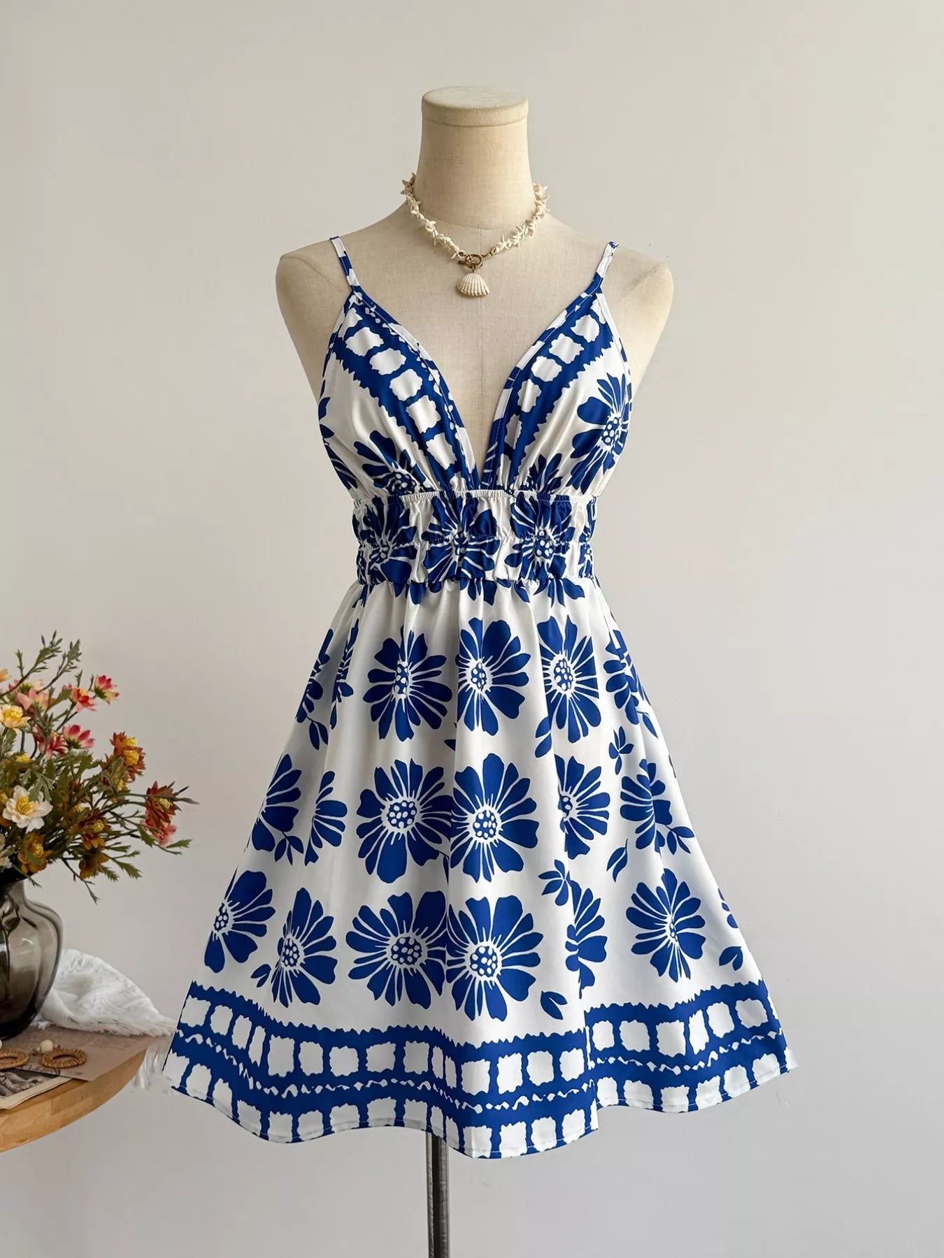 Floral print V-neck mini dress by Pear Daisy, featuring a vibrant floral pattern and lightweight fabric.