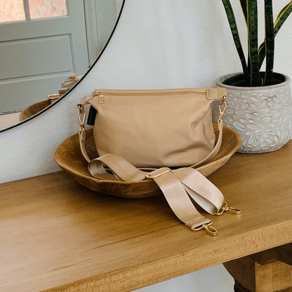 Start2Finish Everly Crossbody accessory bag with adjustable strap and multiple compartments, shown in black fabric.