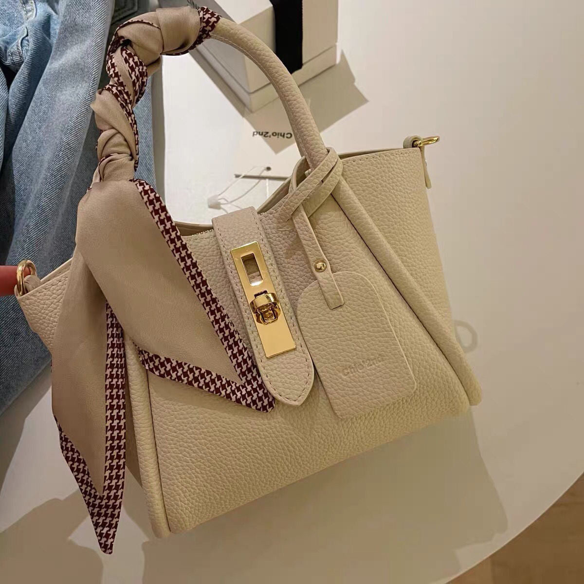 Carmine Juneberry CityEdit™ Litchi Luxe Tote with scarf handle, stylish tote bag with textured litchi pattern and elegant scarf strap.