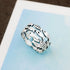 Silver fish ring by Fuchsia Molly featuring a detailed fish design, crafted in sterling silver, shown on a neutral background.