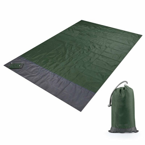 Maroon Asteria portable waterproof camping picnic mat with pocket for beach or outdoor use on sandy surface.