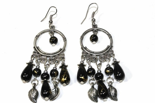 Silver Hestia Flow or Flair versatile dangler earrings with elongated, curved metal designs hanging gracefully from the ears.