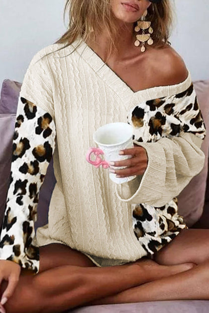 Beige asymmetric leopard patchwork sweater with wide sleeves and V-neck by Carmine Juneberry, stylish and cozy knitwear for women.