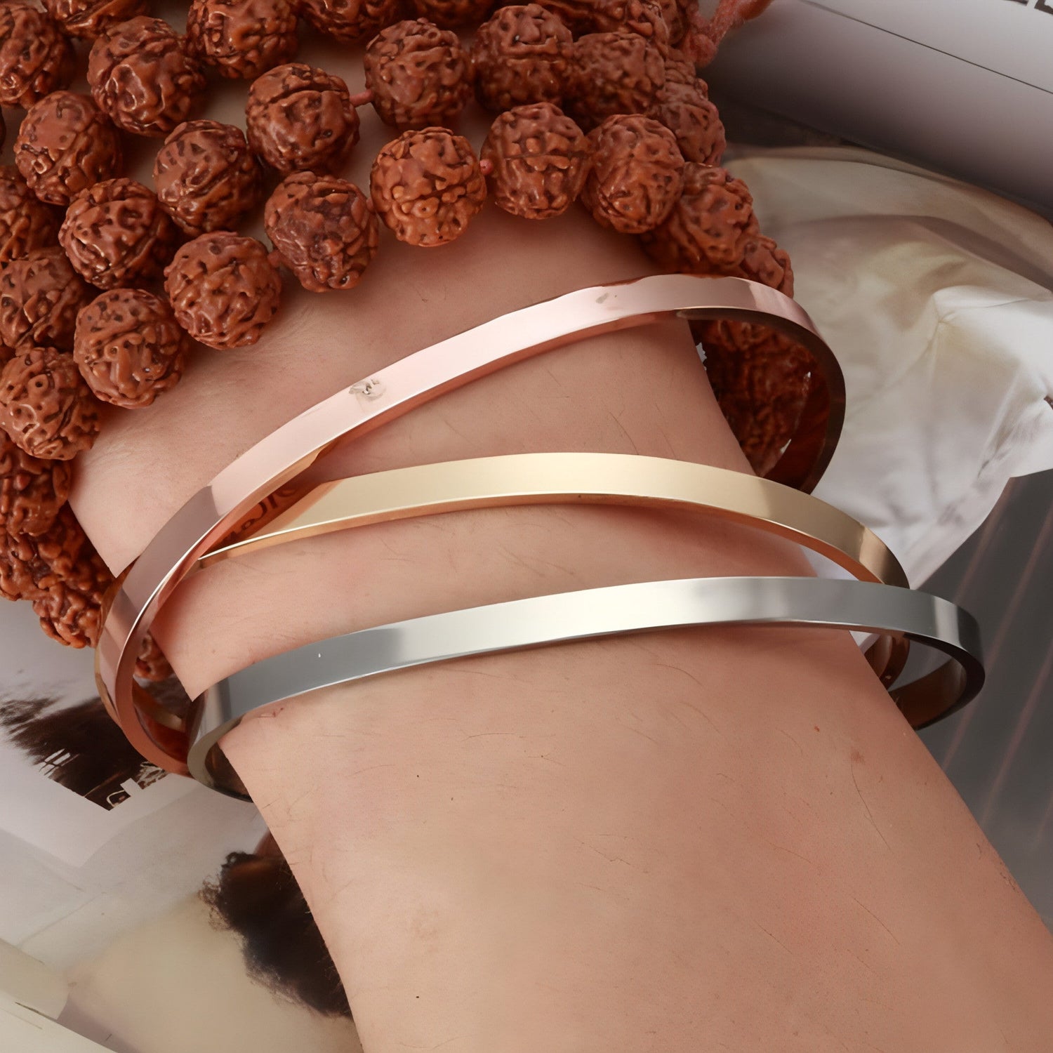 Personalized steel couple bracelet from Carmine Juneberry, sleek design for him and her with engraved details.