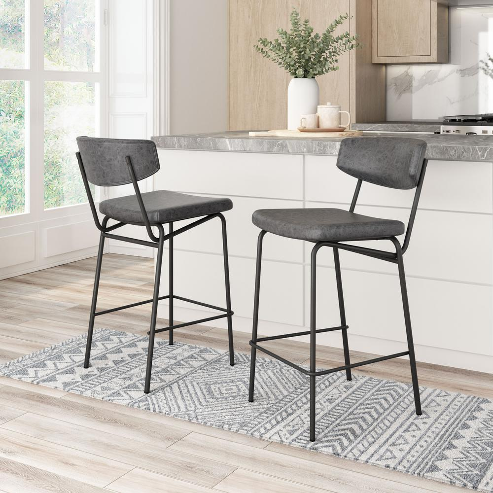 Pair of vintage black Charon counter stools from Start2Finish with metal legs and cushioned seats, set of two for kitchen or bar area.