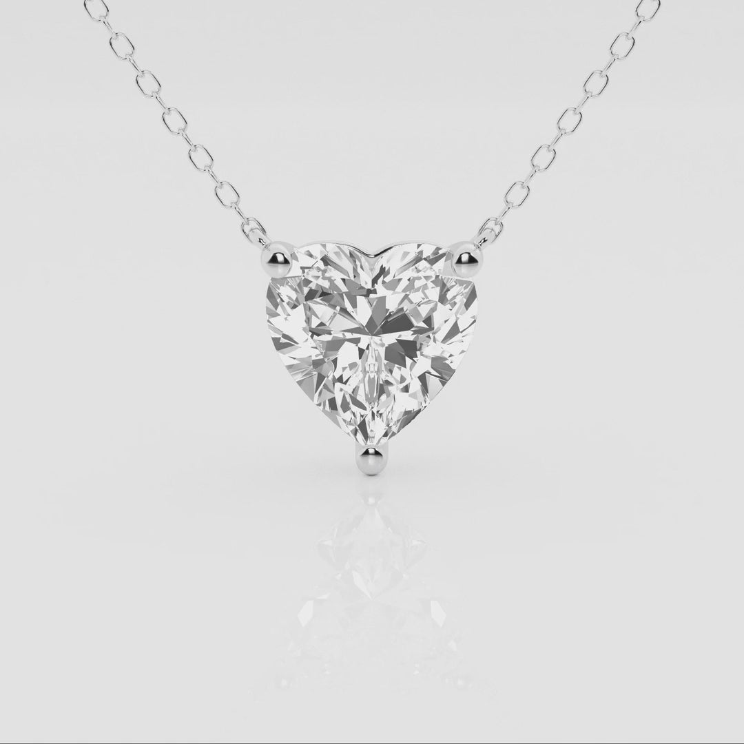 Floating heart-shaped lab-grown diamond pendant necklace in 14K white or yellow gold with F/G VS1 diamonds, AGI certified.