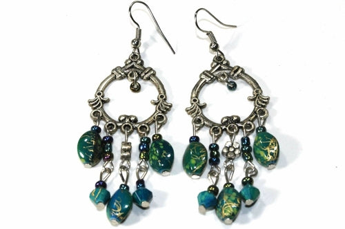 Silver Hestia boho style chandelier earrings with intricate metalwork and dangling bead accents.