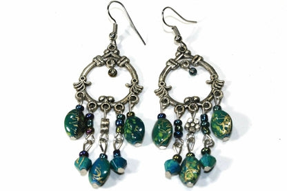 Silver Hestia boho style chandelier earrings with intricate metalwork and dangling bead accents.