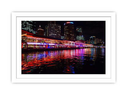 Framed print of Darling Harbour Sydney at night by Start2Finish, showcasing the vibrant cityscape and waterfront lights.
