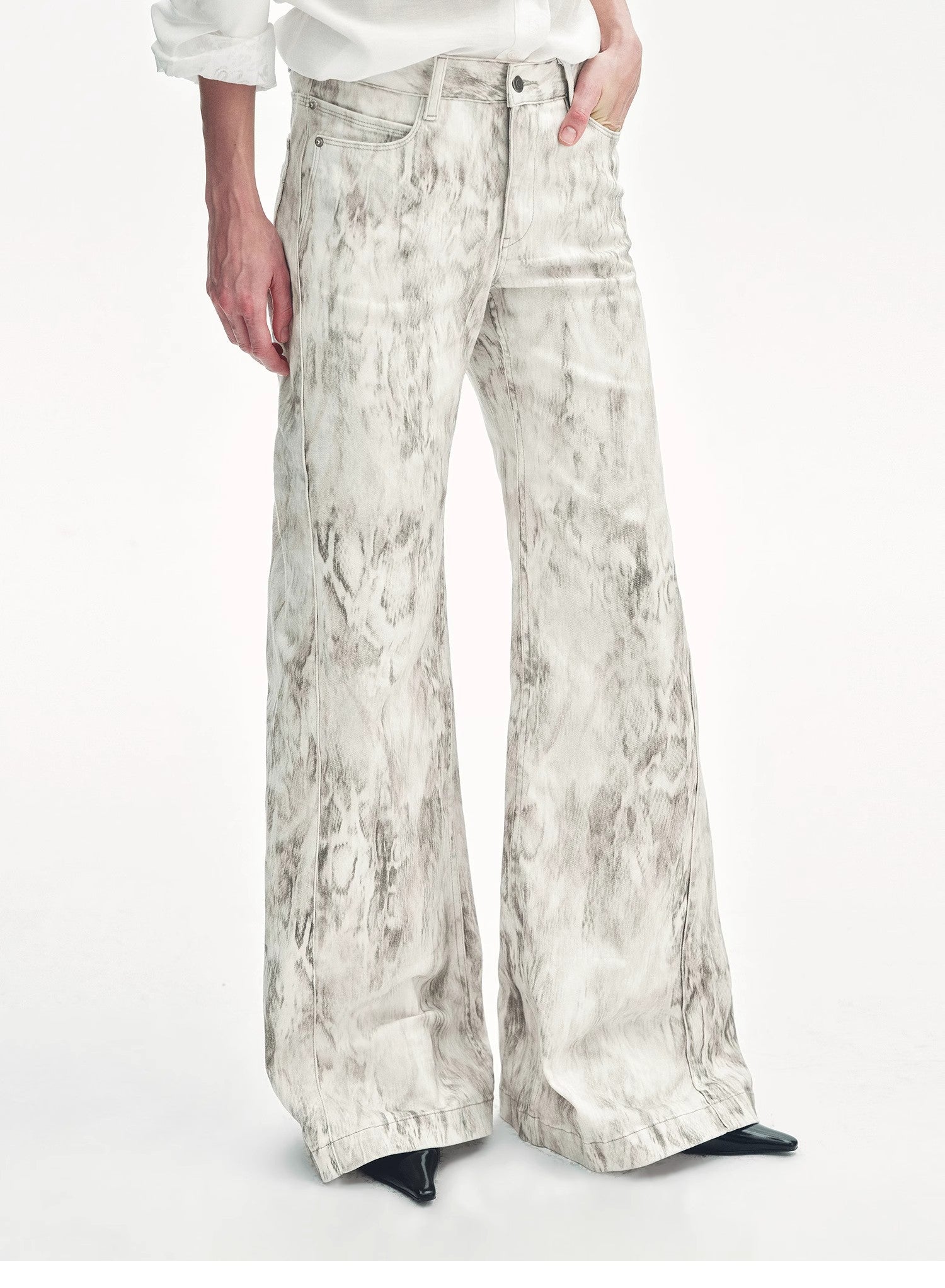 Brown Coeus "Phantom" snake print flared denim trousers, showcasing the unique snake pattern and stylish flared leg design.